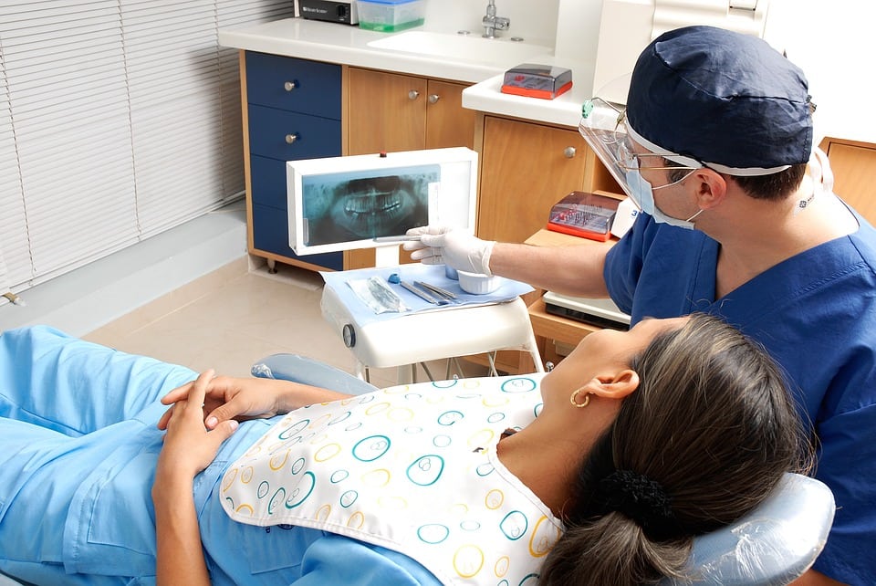 A dentist shows a patient their dental x-rays.